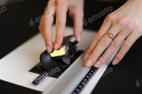 Preview: Girl cuts out a passe-partout from white cardboard close-up