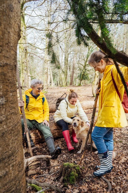 Preview: Group of friends resting with backpacks in forest. Trekking travel in adventure lifestyle, hiking