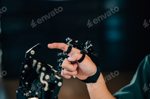 Preview: Asian teenage boy explores technology testing a robot hand and arm for educational growth in a