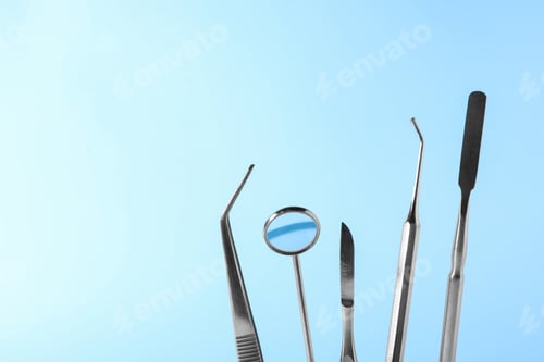Preview: Set of different dentist tools on color background, closeup. Space for text
