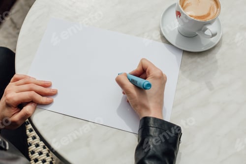 Preview: a girl writes on a sheet the word "Love"