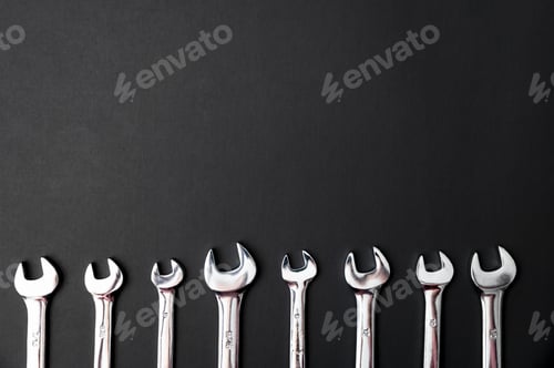 Preview: Top view of different combination wrenches on a black background