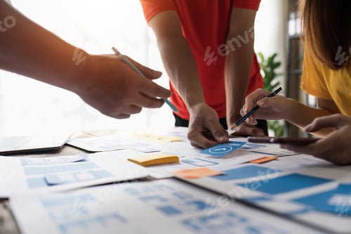 Preview: Close up ux developer and ui designer brainstorming about mobile app interface wireframe design at