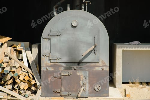 Preview: Rustic gray oven with stacks of firewood. Los Vilos, Chile.