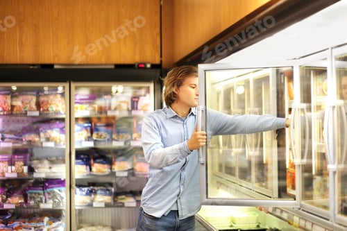 Preview: Man Choosing Frozen Food From A Supermarket Freezer