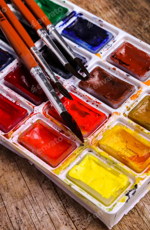 Preview: Palette of Watercolors with Brushes on Wood
