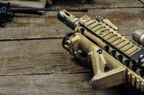 Preview: Close up photo of M16 rifle on wooden board