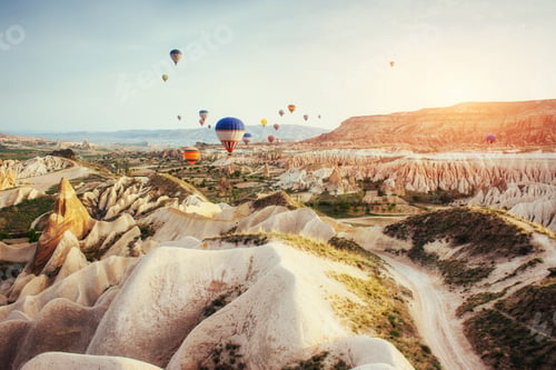 Preview: Hot air balloon flying over rock landscape at Cappadocia Turkey.