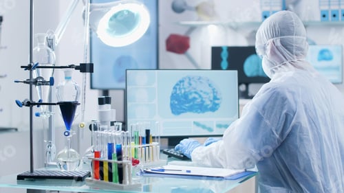 Preview: Specialist researcher with ppe equipment analyzing brain activity typing medical expertise
