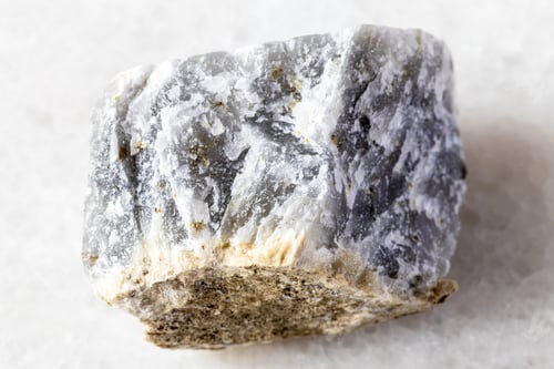 Preview: sample of raw melilite mineral on white marble