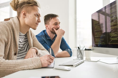 Preview: Two Men Collaborating on Code