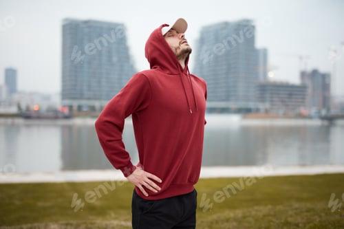 Preview: Athletic Sporty Man Training In Hoodie Sweatshirt In Urban City Park.