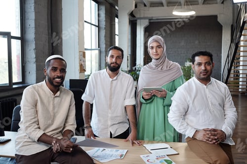 Preview: Four young contemporary economists in traditional Muslim clothes