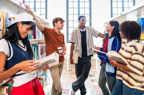 Preview: Multiethnic group of young students studying at library