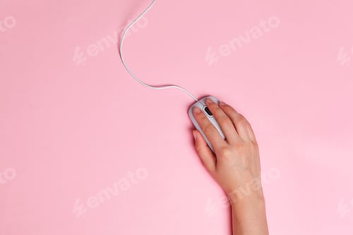 Preview: Woman's hands on a pink office workspace view from above