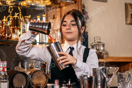 Preview: Female bartender preparing a cocktail in a traditional cocktail bar