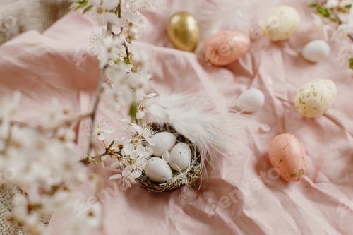 Preview: Stylish easter eggs and blooming spring flowers on pink linen fabric. Happy Easter