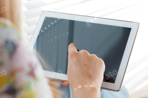 Preview: woman holding digital tablet, closeup