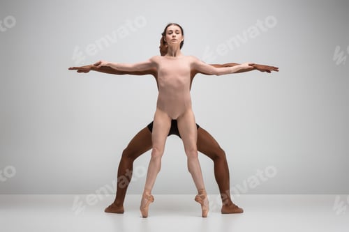Preview: Couple of ballet dancers posing over gray background