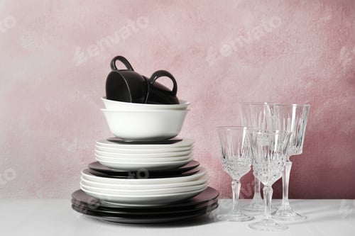 Preview: Set of dinnerware on table against color background. Interior element