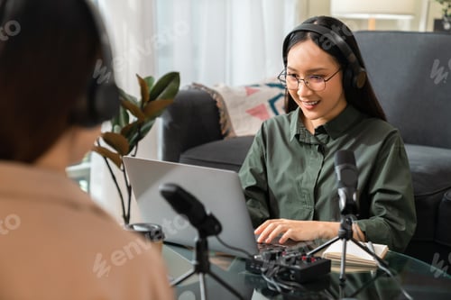 Preview: Young Asian woman use microphones wear headphones with laptop record podcast interview for radio.