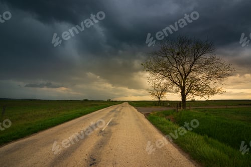 Preview: Dark storm clouds over the country road , moody dark sky