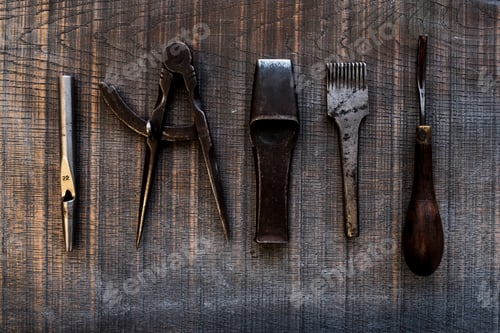 Preview: High angle close up of selection of saddle making hand tools.