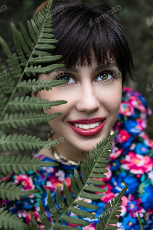 Preview: Romantic portrait of a woman in a fern in the forest. Art woman natural makeup resting in nature. Gr