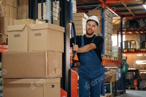 Preview: Preparing boxes for shipment by moving them by forklift. Man in uniform is working in the storage