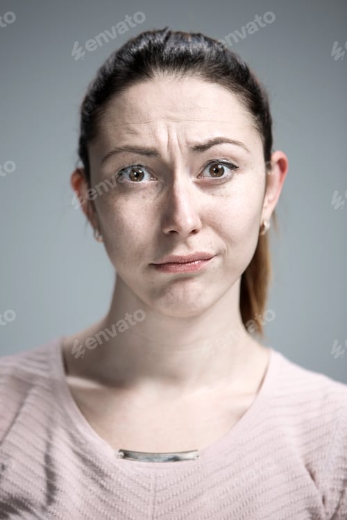 Preview: Woman Is Looking Imploring Over Gray Background