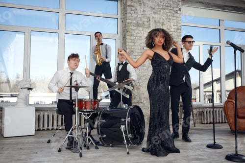 Preview: Repetition of multi ethnic jazz band in loft. Bass guitar player, electric guitar player