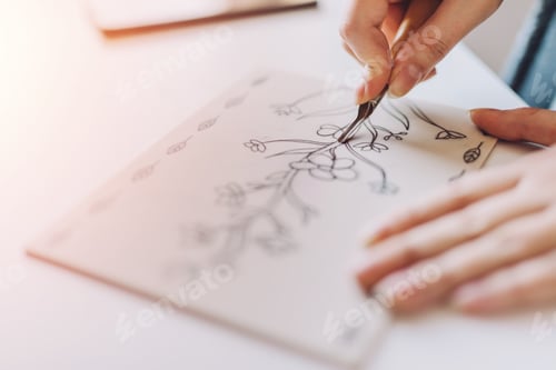 Preview: Concentrated crop woman doing linearity and first sketches in office
