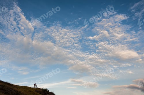 Preview: Silhouette of a cross country cyclist going downhill