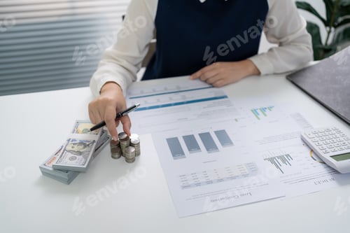 Preview: Businesswoman Accountant analyzing investment charts Invoice and pressing calculator buttons over