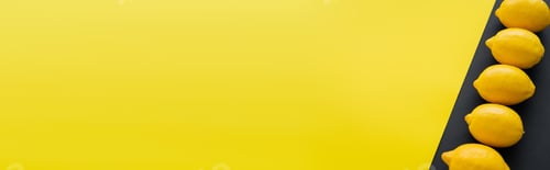 Preview: Top view of organic lemons on yellow and black background, banner