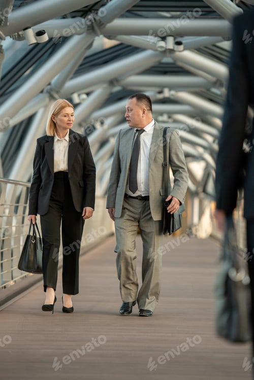 Preview: A man and a woman discussing contract terms on the move