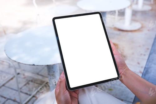 Preview: Mockup image of a woman holding digital tablet with blank white desktop screen in the outdoors