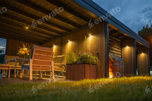 Preview: Cozy Outdoor Seating Area Featuring Wooden Furniture and Ambient Lighting