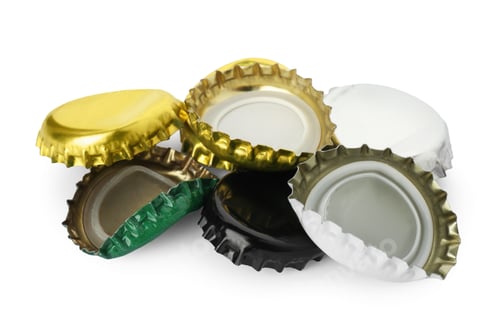 Preview: Group of different beer bottle caps isolated on white