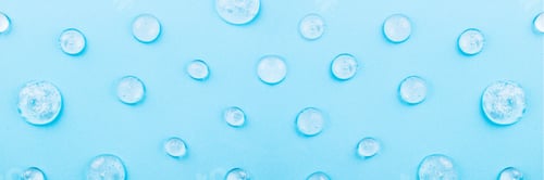 Preview: Liquid gel cosmetic on blue. Texture of gel on blue background. Pattern of transparent drops gel