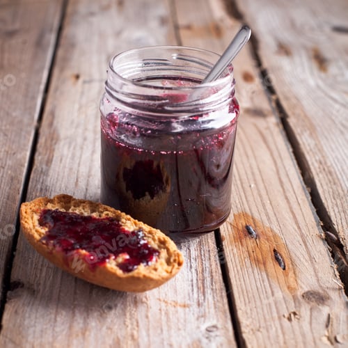 Preview: black currant jam in glass jar and cracker