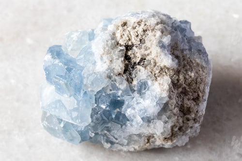 Preview: sample of rough celestite rock on white marble