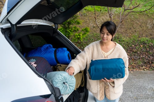 Preview: Woman take out the camping tent from the car