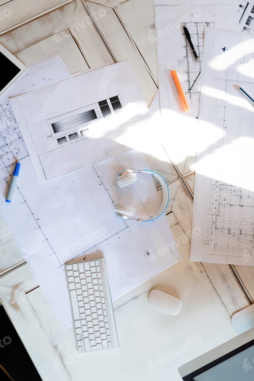 Preview: Top view of tablet on worktable with blue print and sketch