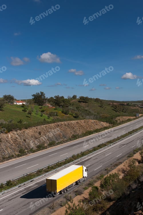 Preview: view of motorway with yellow truck