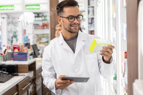 Preview: Male pharmacist working in a pharmacy.