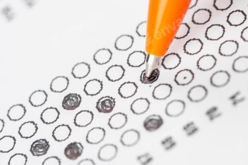 Preview: Person filling out a multiple choice test with a pen on a printed answer sheet
