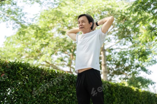 Preview: Man Stretching Outdoors in a Green Park