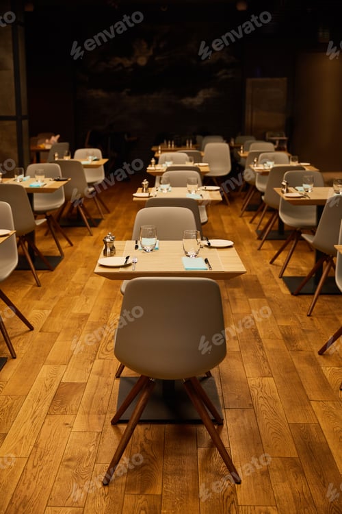Preview: glasses near plates and tissues on wooden tables
