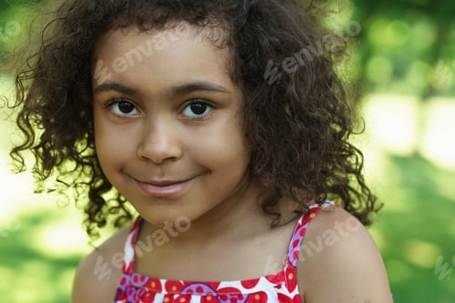 Preview: Portrait of cute black girl in a city park